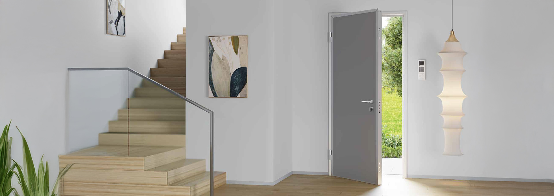 Sicurezza certificata Alias Roma: protezione per appartamenti di design Porta blindata Alias in grigio satinato installata all'ingresso di un appartamento moderno con scala in legno e parapetto in vetro.