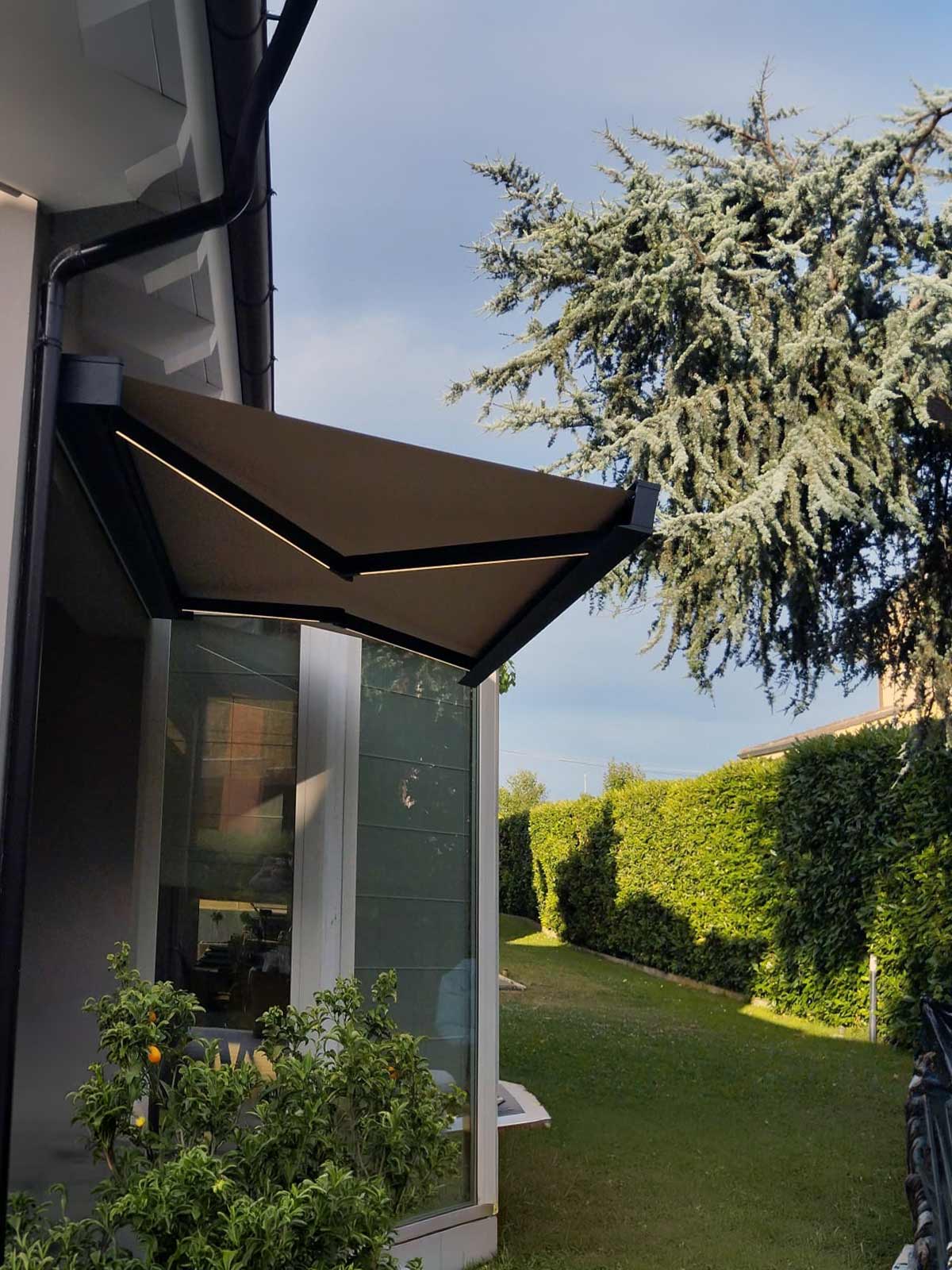 Tenda da sole a cassonetto KE Qubica Flat aperta con illuminazione LED integrata nei bracci
